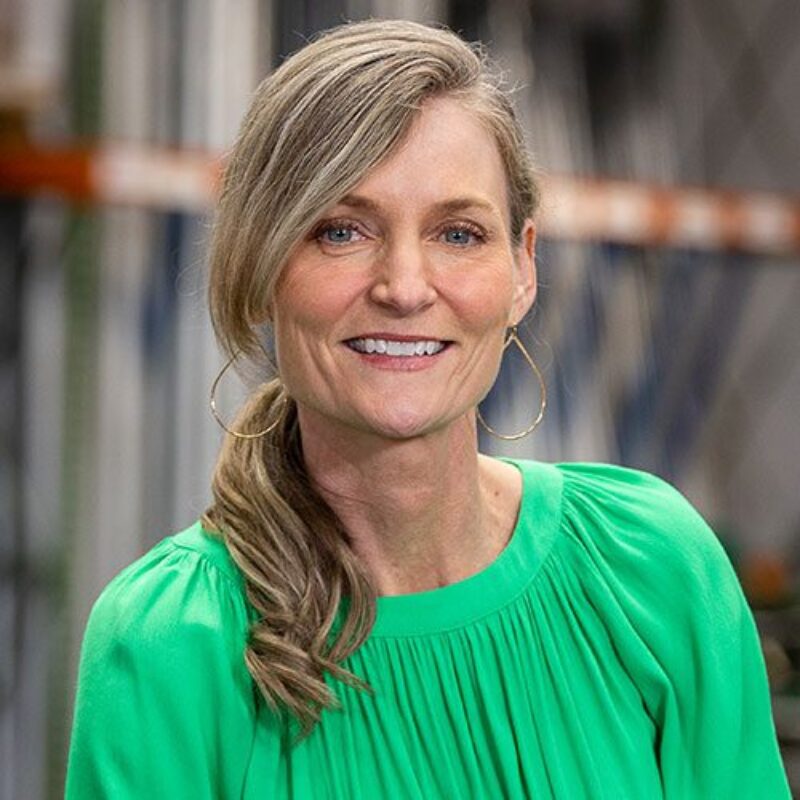 Smiling woman wearing a green blouse